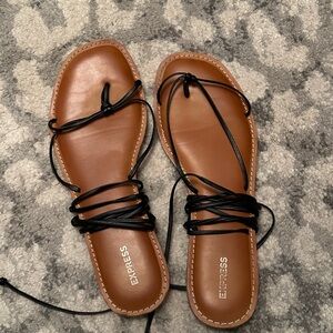 Express brand. Women’s 10. Black flat sandal with straps for ankle and legs.